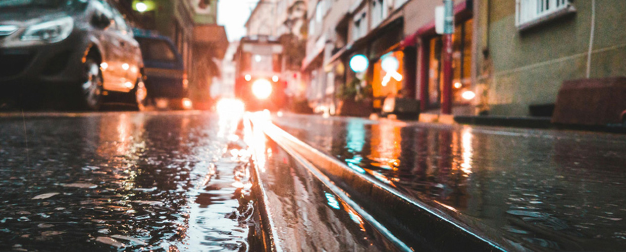 Wet urban street reflecting colorful lights from shops and cars Wet urban street reflecting colorful lights from shops and cars - https://murphyinsgrp.com/