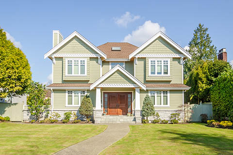 Two-story suburban house with green siding, white trim, and a symmetrical design - https://murphyinsgrp.com/ 